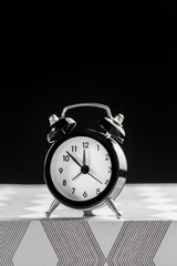 Vintage background with retro alarm clock on table