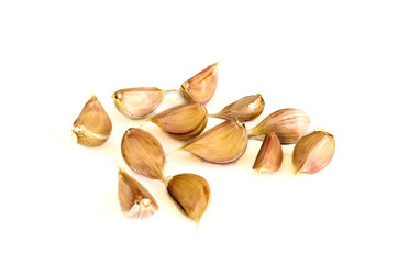 Brown garlic cloves isolated on white background.