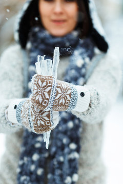 Beautiful girl with icicle in her hands
