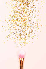 Pink makeup brush and confetti