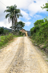 Rise on dirt road, with barn in the background, blue sky with clouds, Presidente Nereu, Santa Catarina