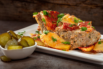 Homemade moussaka with pickles