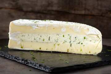 Slice of brie cheese with cream and other herbs