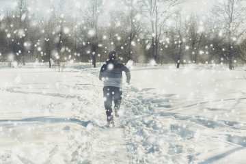 Fototapeta na wymiar Two teen boys walk with ski in the park in the winter snowfall. Concept of friendships