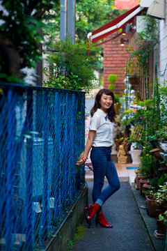 Asian female model poses for pictures on the street