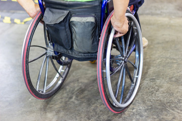 Disabled people sitting on wheelchair and going outdoor