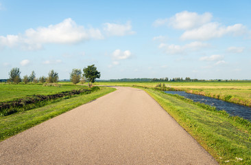 Fototapeta na wymiar Curved road in a flat polder landscape