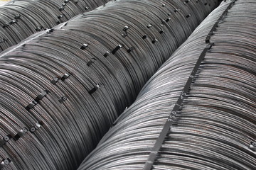 Coils of galvanized steel metal rod wire in a warehouse