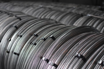 Coils of galvanized steel rod wire in a warehouse
