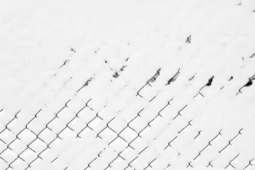 Wire fence covered snow winter white
