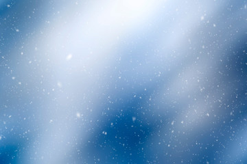 Fototapeta na wymiar Beautiful blurry bokeh with snowflakes. Winter season copy space background.