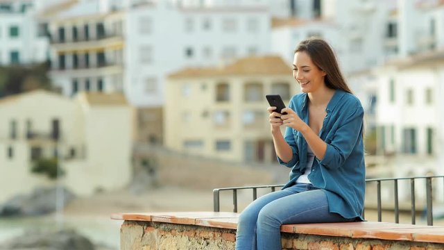 Happy woman using smart phone until her boyfriends arrives and then they contemplate views together