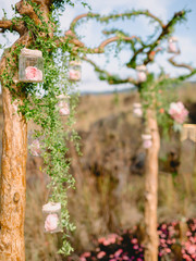 Obraz premium Floral decoration for wedding ceremony. Rustic arch with beautiful flowers.
