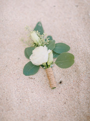 Wedding boutonniere with roses flowers and eucalyptus