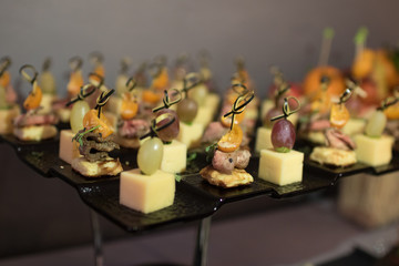 Beautifully decorated catering banquet table with different food snacks and appetizers on corporate christmas birthday party event or wedding celebration