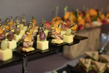 Beautifully decorated catering banquet table with different food snacks and appetizers on corporate christmas birthday party event or wedding celebration