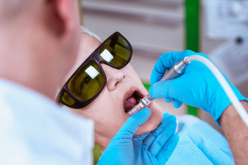 Teeth Whitening. Senior Woman In A Dentist Chair