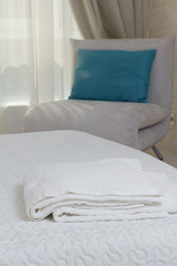 Fototapeta na wymiar two white towels on the bed in the hotel