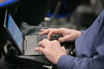 Businessman using laptop computer. Close up of male hands typing on laptop keyboard. Business working concept. Blogger, journalist writing new article