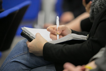 Journalist is taking notes during a conference