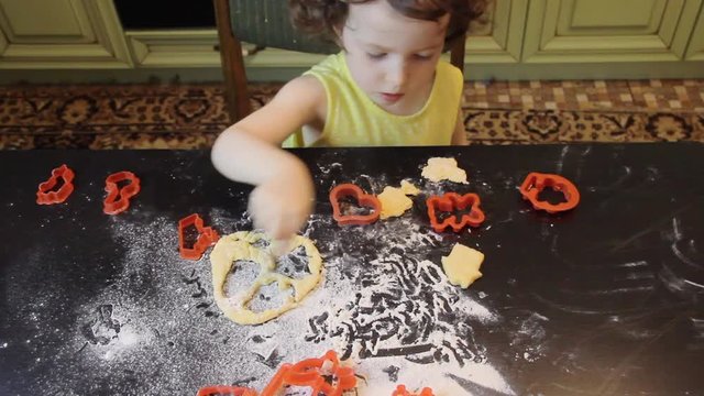 Little Pretty Child Girl Making Cinnamon Gingerbread Cookies. Christmas And New Year 2019 Concept. Red Plastic Forms, Yellow Dress, Mint Green Kitchen