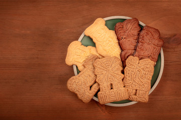 Traditional German Christmas Spekulatius cookies, shot from the top on a dark rustic wooden background with a place for text