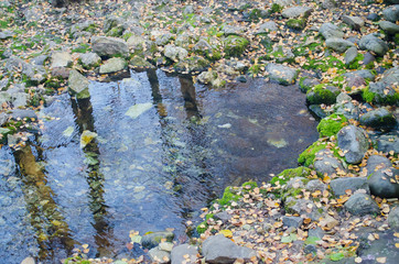 Source of drinking water, surrounded by old stones.