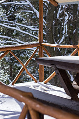 Wooden arbor in the winter in the snow