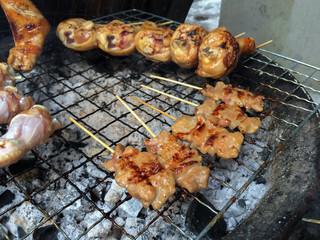 Thai grilled pork and grilled chicken on the flaming grill, Thai food style...