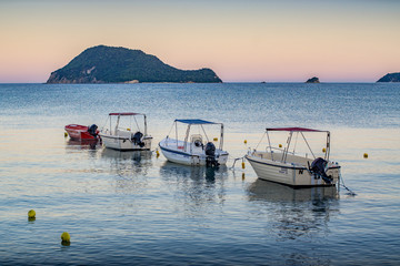 Fototapeta na wymiar Four boats in a row at Laganas beach - Zakynthos