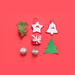 Christmas composition, mockup on red background. Christmas white and silver ribbon, gift box, garlands, toys border with copy space. Flat lay, top view