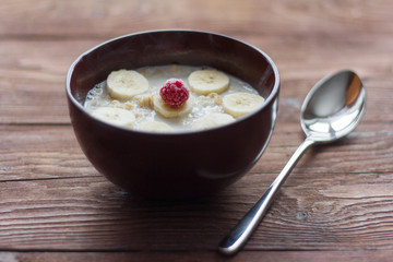delicious hot oatmeal with fruit and berries on wooden background, healthy Breakfast