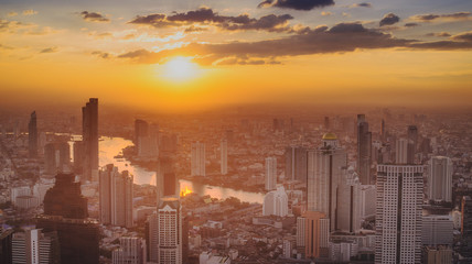 Bangkok City skyline with urban skyscrapers at sunset,City during warm sunset .