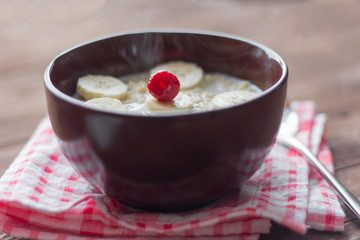 delicious hot oatmeal with fruit and berries on wooden background, healthy Breakfast