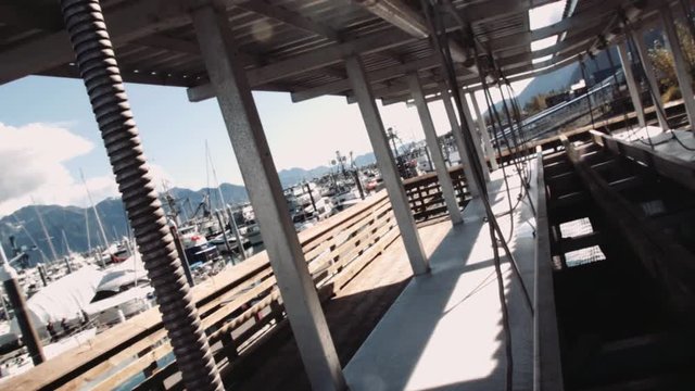 Fish cleaning station in Seward Alaska pan down with flare