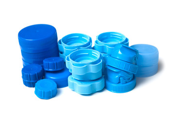 closeup of blue plastic plugs for recycling on white background