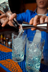 Bartender is stirring cocktails on the bar counter
