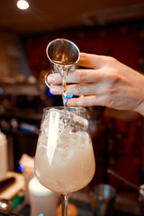 Bartender is stirring cocktails on the bar counter