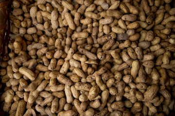 Peanuts in shell texture background. Raw peanuts on display at a farmer