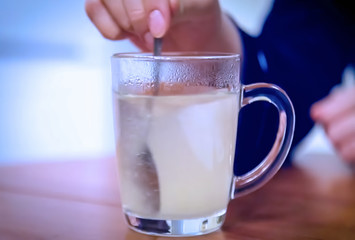 Abstract, blur, bokeh background, defocusing - image for the background. Take your medication. The girl takes drinking water. Woman hold pill blister. The concept of flu and cold