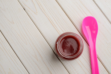 Baby food and colorful spoon