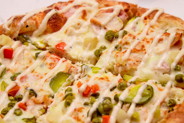 Close up: Delicious Pizza with Mozarella, Pickles, Cheese, Beef, Chilli Jalapeno Pepper, Olive, Green Pepper and Tomato