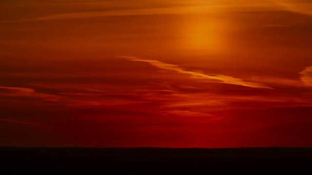 Long Shot of beautiful orange sunset sky with complete sun