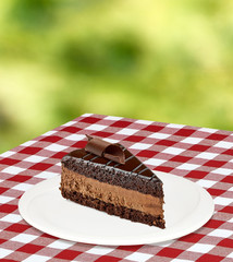 Chocolate or devils cake slice in plate on table
