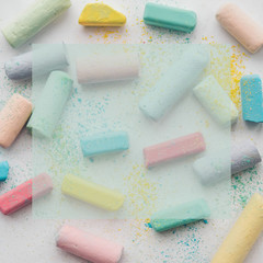 Colorful chalk on white background . Kids education. Close up. Education background. Frame. Copy space.