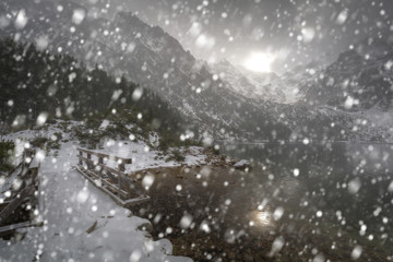 Fototapeta na wymiar Heavy snowfall at Eye of the Sea lake in Tatra mountains, Poland