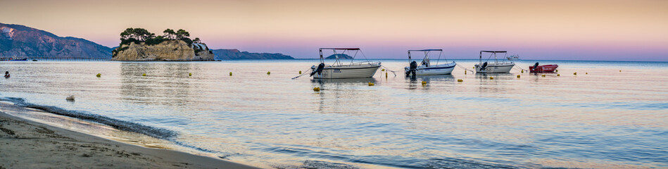 Obraz premium Four boats in a row after sunset 