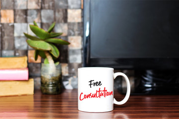 Writing showing Free Consultation on coffee cup