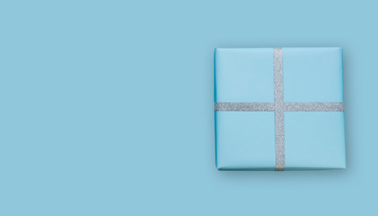 Editable or custom light blue background with gift box   and silver ribbon           