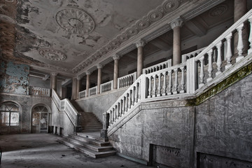abandoned hall of a rich hotel with columns, the luxury of decline